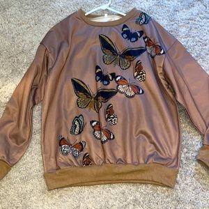 Brown and black sweater with butter flies